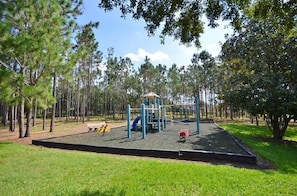 A playground with a slide, climbing structures, and a small shelter. - Conservation View | Pool & Spa | 7 Miles Disney 203 (Davenport)