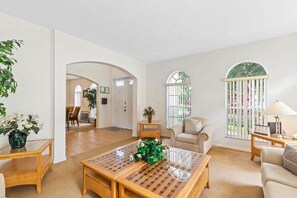 Relax in this spacious living area with a central coffee table and comfortable seating options.
