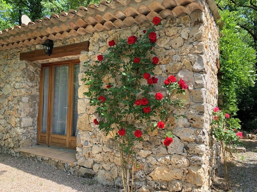 A stone building with a wooden door and a small porch.