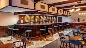A bar area with wooden bar stools, a bar counter, and a chandelier. - African Sky Hotels - Ermelo Inn (Ermelo)