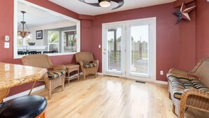 A spacious living room with a dining area, large windows with blinds, and a ceiling fan. - Wasatch Oaks Retreat (Cottonwood Heights)