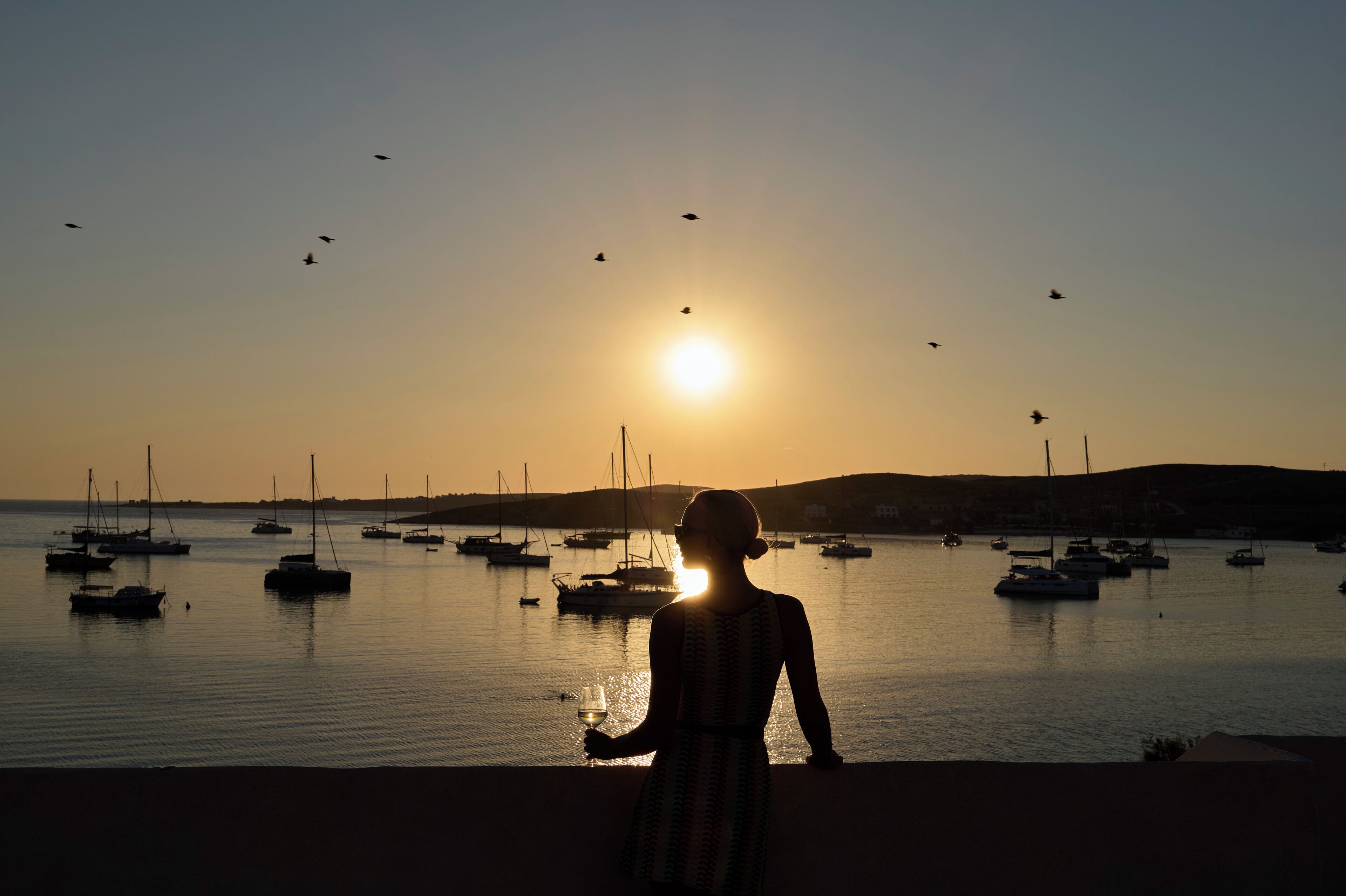 Escena costera con barcos y cielo despejado.