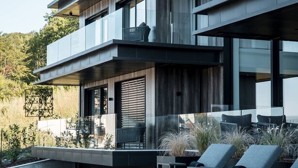 A modern multi-story house with a pool, outdoor seating, and a view of the surrounding landscape. - Villa Tomar (Talloires-Montmin)