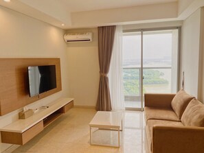 32-inch LED TV with cable channels - Gold Coast PIK Sea View Apartments by Rentrooms (Jakarta)