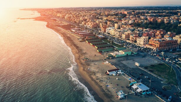 An aerial view of a coastal city with a beach, buildings, and a road. - MiTuCasa Holiday Apartment in Rome (Vitinia)