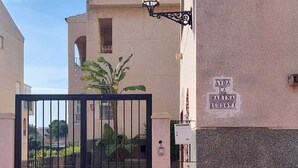 A gated entrance with a sign reading "AVDA LA MARINA RUMBONI".