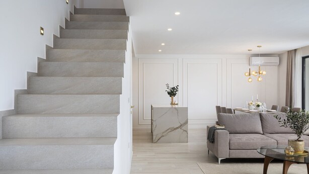 A modern living room with a marble staircase, a dining area, and a sofa. - Villa Bohemian Rhapsody with Pool (Marčana)