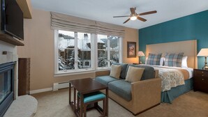 A cozy bedroom with a bed, a sofa, a small table, and a ceiling fan. - Hyatt Mountain Lodge Beaver Creek, Colorado - Prime Ski & Summer Weeks Available (Avon)