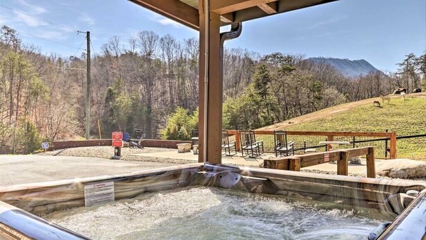A hot tub area with a view of a forested hillside. - Secluded Upscale Smoky Mountain Retreat - Hot Tub, Game Room,  Near Pigeon Forge (Sevier County)