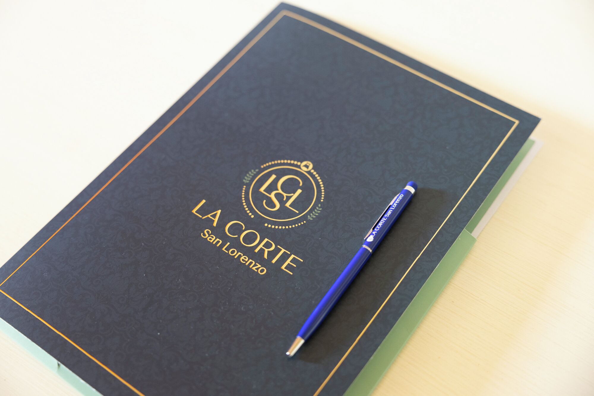 A notebook with a blue pen on top.