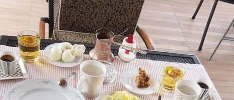 A table set with various food items including bread, cheese, meats, and condiments, suggesting a meal setup.