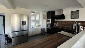 A modern kitchen with stainless steel appliances, a built-in oven, and a microwave.