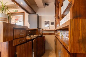 Kitchen features a central island, microwave, and potted plant.