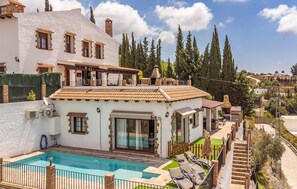 A villa with a swimming pool, outdoor seating, and a view of the surrounding landscape. - 3 bedroom beautiful home in Mijas (Mijas)