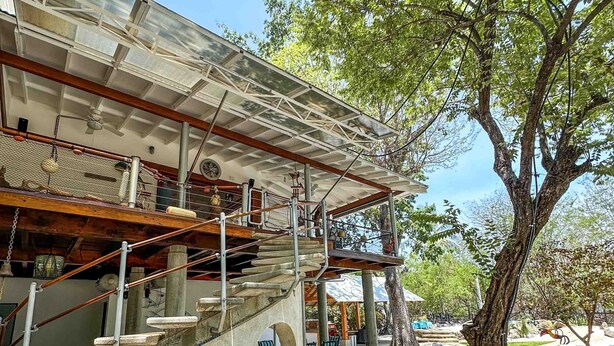 A multi-level outdoor structure with a staircase, a covered seating area, and a large tree. - Beachfront Villa – Just Steps from the Sand, Your Ocean Escape Awaits (Guanacaste Province)