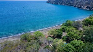 A coastal landscape with a beach, dense greenery, and a clear blue sea. - Beachfront Villa – Just Steps from the Sand, Your Ocean Escape Awaits (Guanacaste Province)