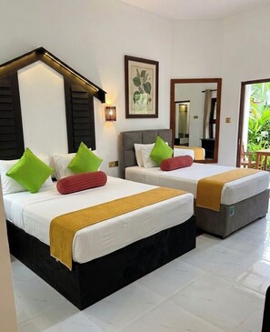 A hotel room with two beds, a large mirror, and a framed botanical print on the wall. - Sunshine Resort and Spa (Sigiriya)