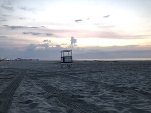 Enjoy a serene beach experience with a lifeguard stand and access to green lagoons.
