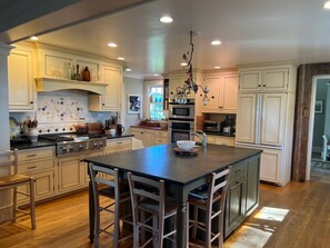 Enjoy cooking in this well-equipped kitchen with a large island, oven, and ample counter space.