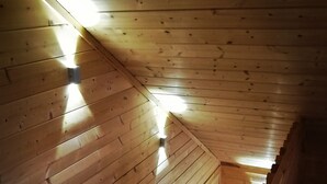 A wooden staircase with a sloped ceiling and built-in lighting. - Stylish 2 Bdr. cottage, with sauna and all the necessary commodities (Österhankmo)