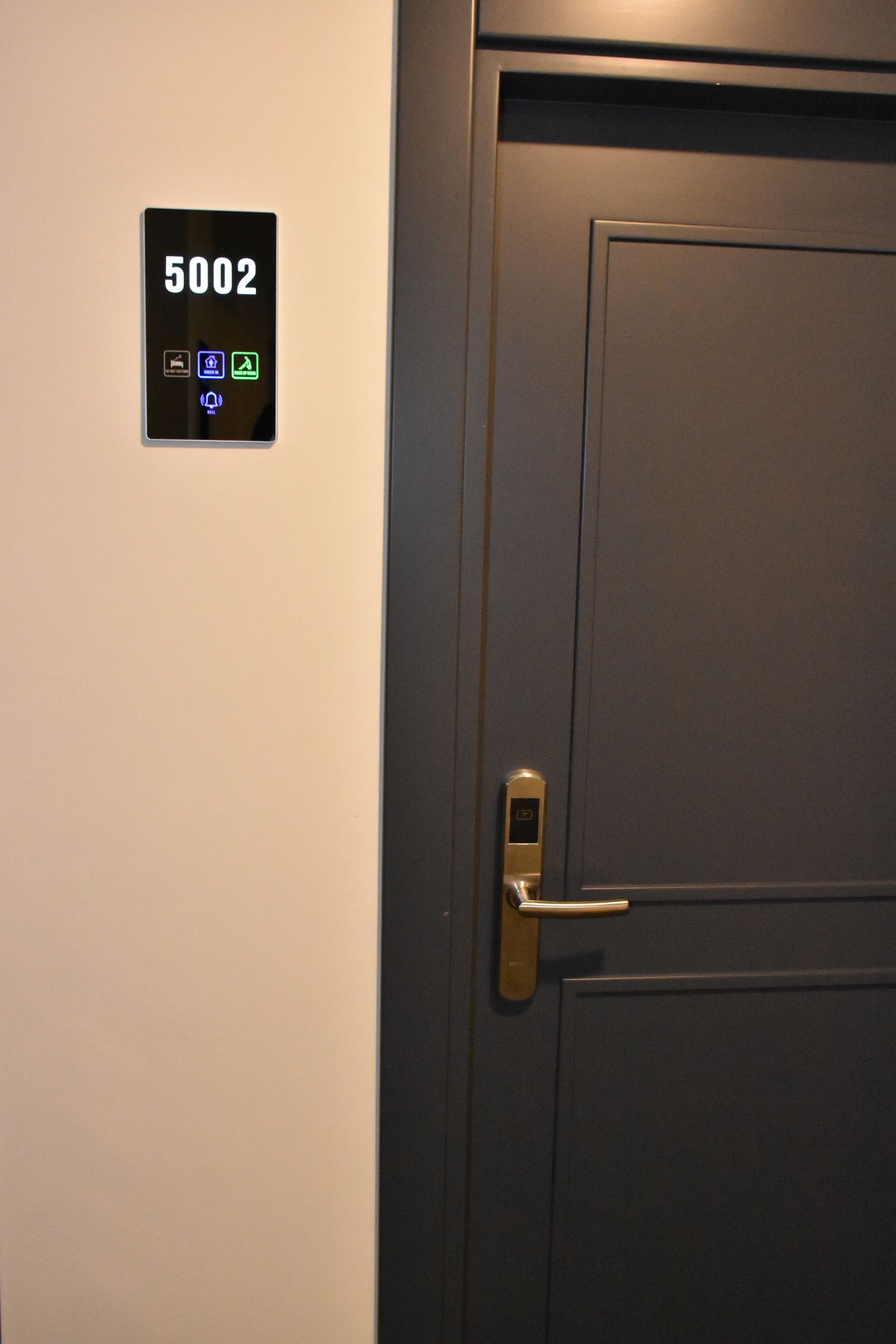 A door with a digital keypad and a lock.