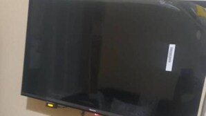 A flat-screen TV mounted on a wall. - Habesha circle (kampala)