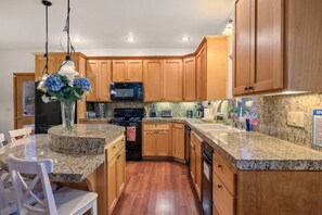 Enjoy meals in the kitchen with a dining area and modern appliances.