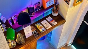 A staircase with a striped floor leading to a reception area with a desk, books, and a sign. - La Vien Hotel Old City (Istanbul)