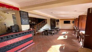 A spacious living area with a staircase, a dining table, and a kitchen area. - MeroStay 149 HE (Bhaktapur)