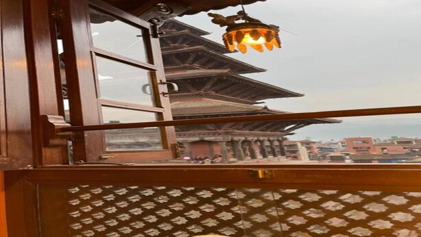 A traditional building with a tiered roof and a hanging light fixture. - MeroStay 149 HE (Bhaktapur)