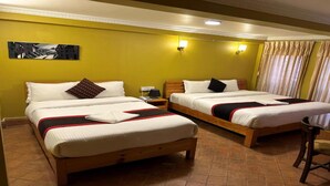 A hotel room with two single beds, a small table, and a chair. - MeroStay 149 HE (Bhaktapur)