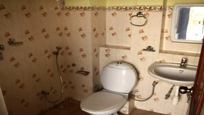 A bathroom with a toilet, sink, and shower. - Merostay 158 Hotel RM (Kathmandu)