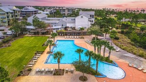 A resort with a large swimming pool, lounge chairs, and a view of the surrounding buildings. - Windmark Beach! Heated Pool, Water View, Loaded, Golf Cart! Weekly Stay Disc! (Port St. Joe)