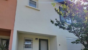 A two-story building with a white facade, a small window, and a door. - Renovated house, Collioure near center, mountain views, quiet (Collioure)