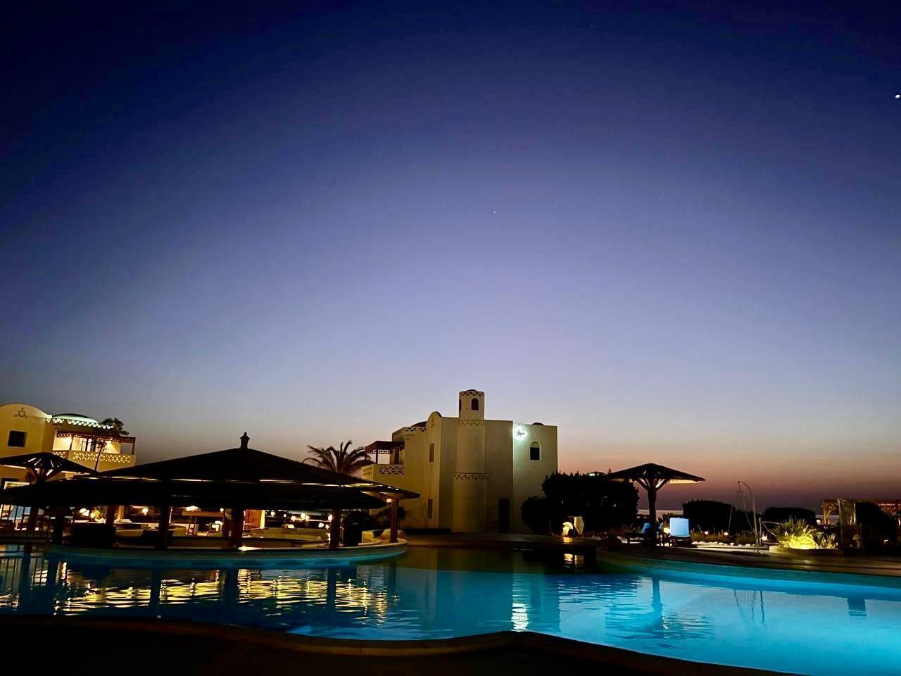 A swimming pool with a building in the background.