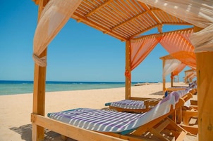 Private beach, white sand, sun loungers, beach umbrellas