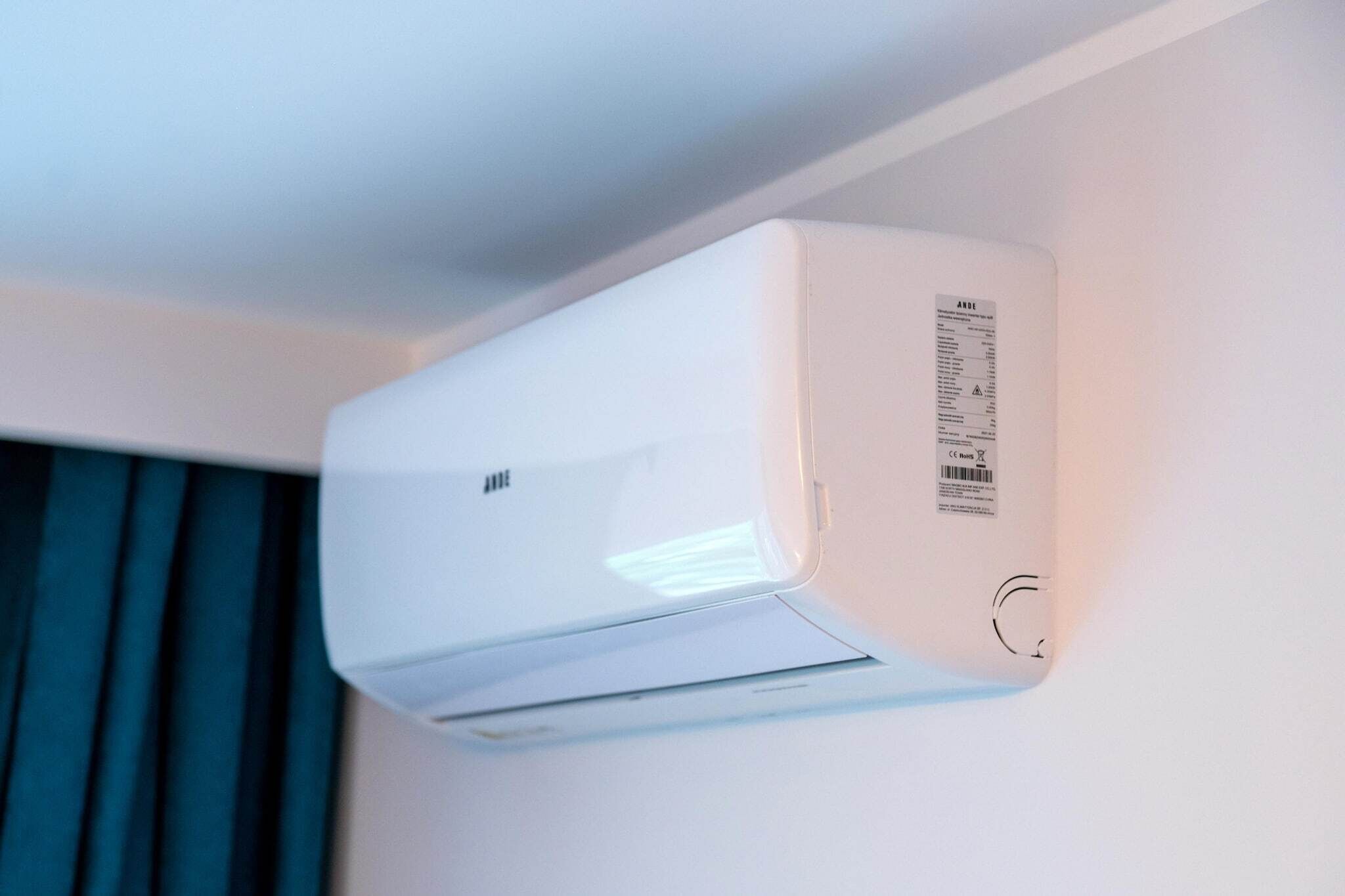 A white air conditioning unit mounted on a wall.