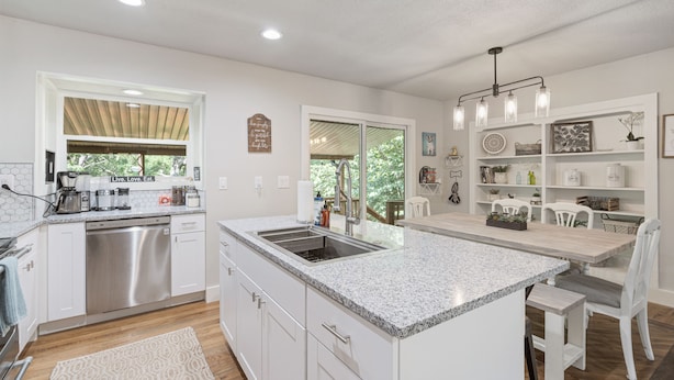 A modern kitchen with white cabinetry, a granite countertop, and stainless steel appliances. - Bella's Vista - Hound Dog Haven (Bella Vista)