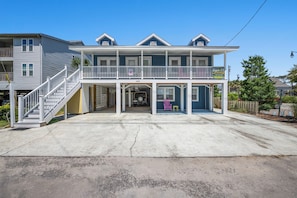 A two-story house with a front porch, a staircase, and a garage.
