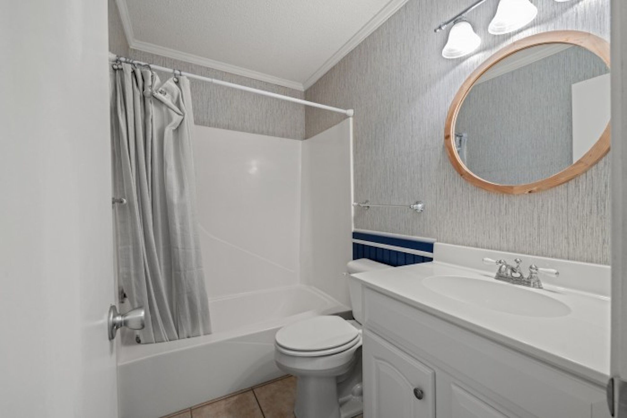 A bathroom with a bathtub, toilet, and sink.