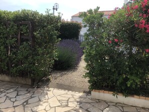 Stroll through lush gardens to a serene entrance.
