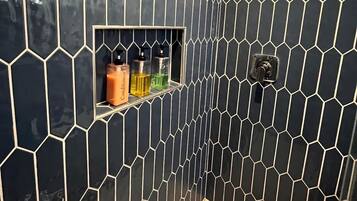 Bathtub, hair dryer, towels, shampoo