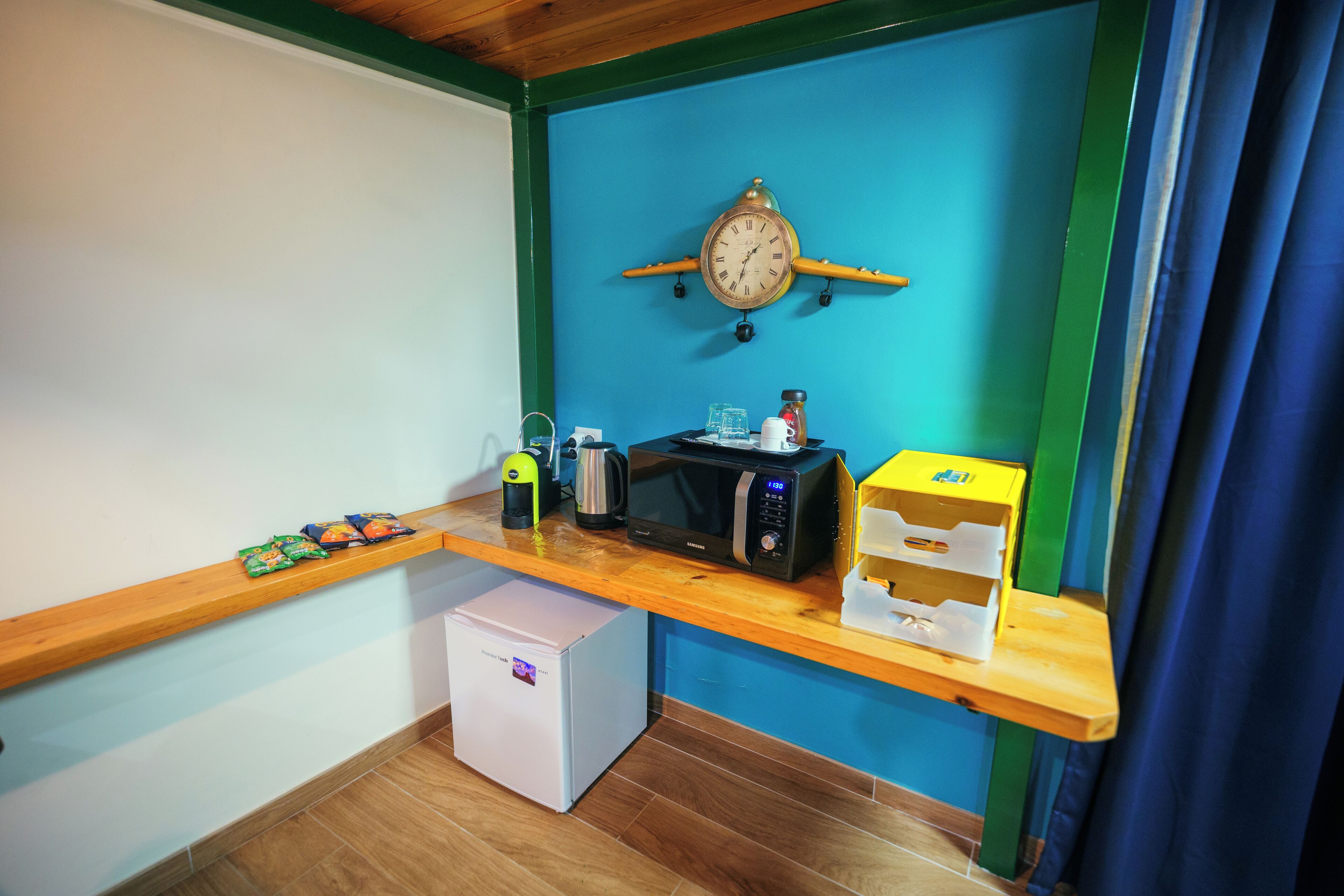 A compact kitchenette with a microwave, toaster, and small refrigerator.