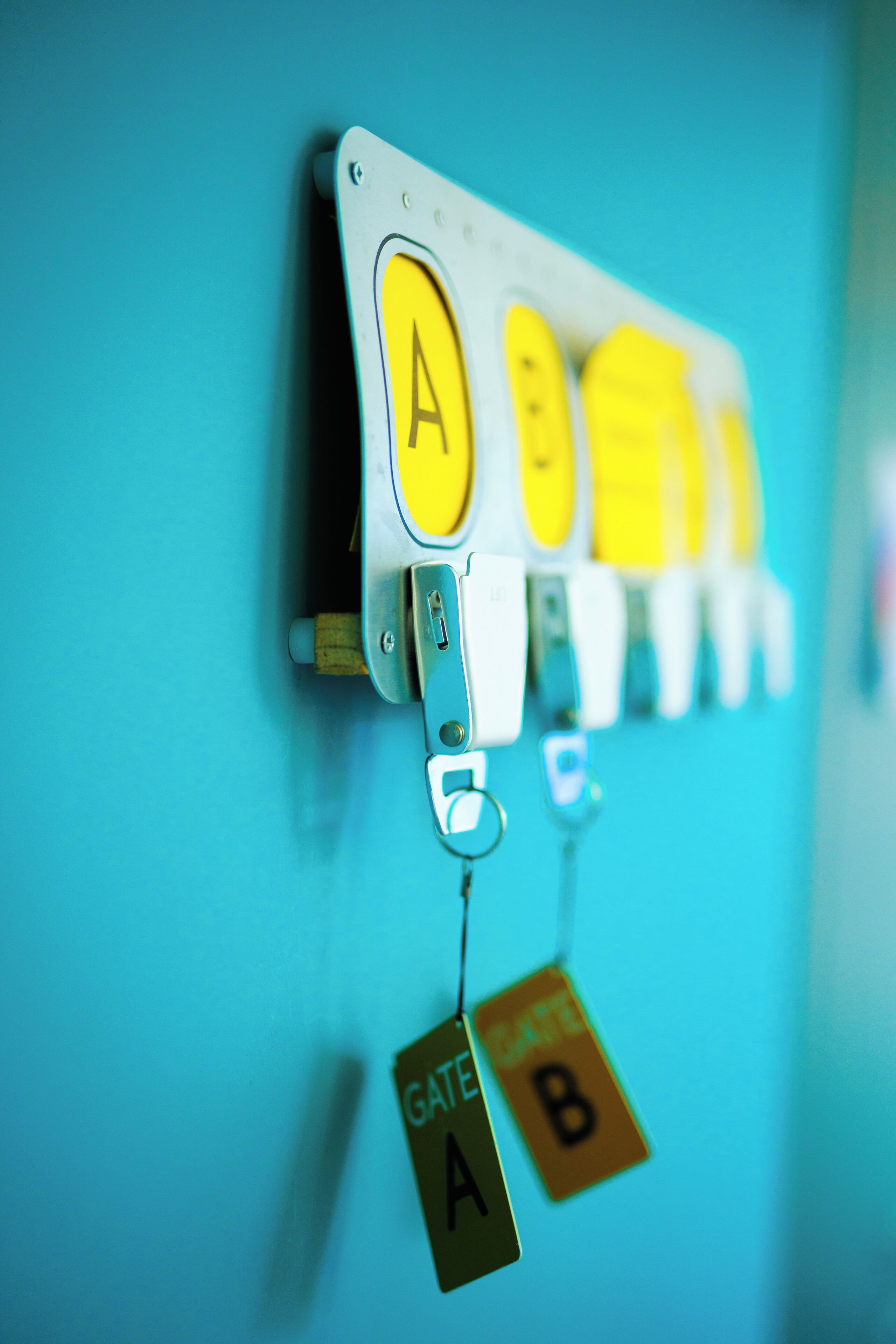 A wall-mounted control panel with labeled buttons and tags indicating gate numbers A and B.