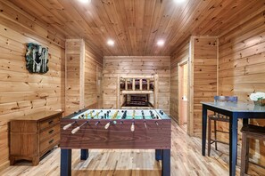 Relax in this inviting room with a central foosball table and comfortable seating areas.