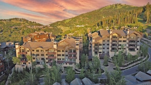 A resort with multiple buildings, including a large hotel with balconies and a smaller building with a ski lift. - Arrowleaf by Luxury Mountain Destination (Park City)