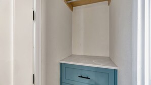 A small, narrow room with a single blue drawer unit and a white countertop. - Coastal hideaway w/ beach access & workspace (San Clemente)