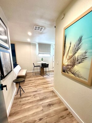 Relax in a stylish room with a comfortable bed, seating area, and natural views.