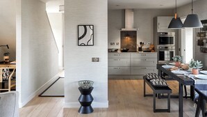 A modern kitchen with grey cabinets, a central island, and pendant lighting. - 3 bedroom accommodation in Croy, near Inverness (Croy, near Inverness)