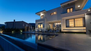 A modern two-story house with a swimming pool, outdoor seating, and large windows. - Cozy home in Kastel Stari with sauna (Kastel Stari)